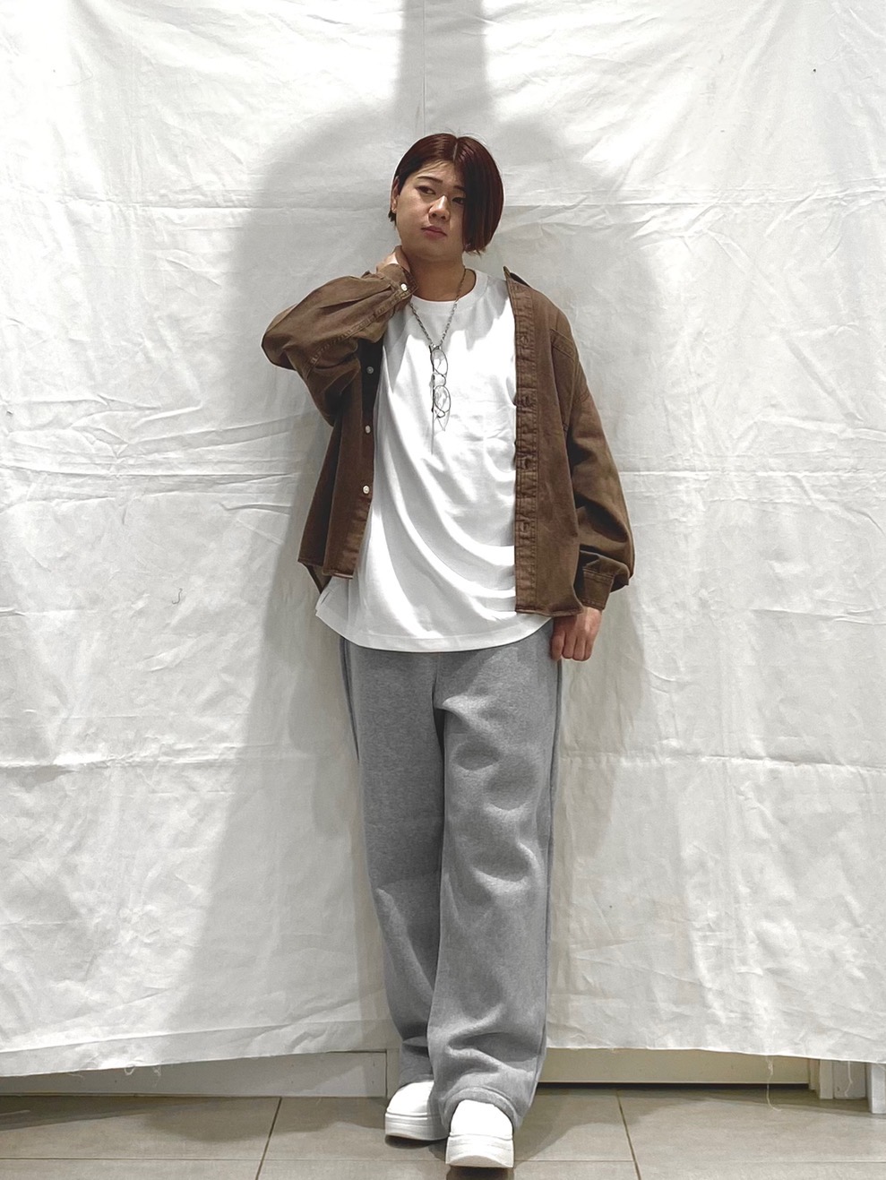 Brown workwear overshirt over a white T-shirt with gray sweatpants