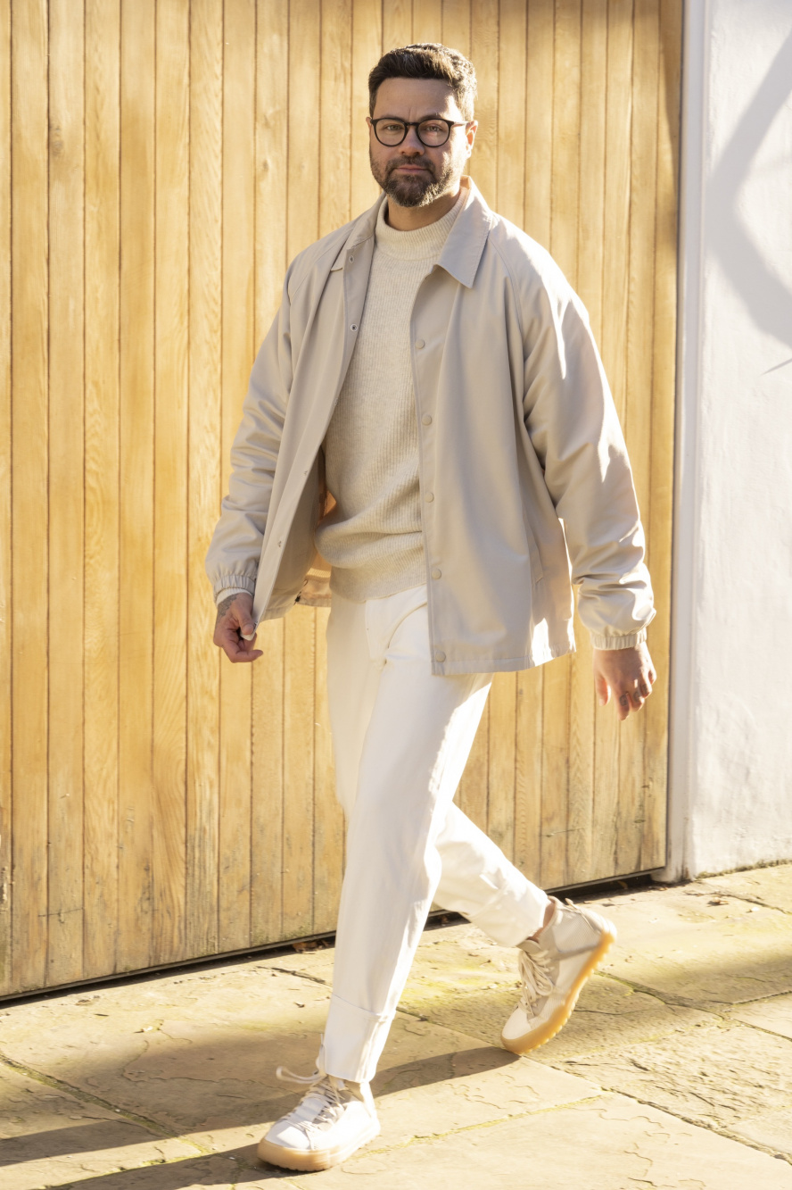 Men's autumn winter outfit with beige plain coach jacket, white plain  turtleneck knit, brown plain chinos, gray plain socks, beige moccasins/deck  shoes leather shoes.